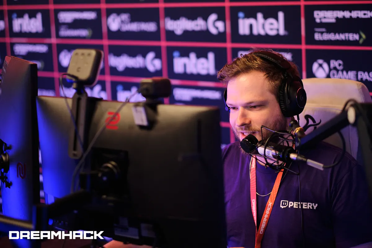 Petery streaming at DreamHack, wearing headphones and speaking into a microphone