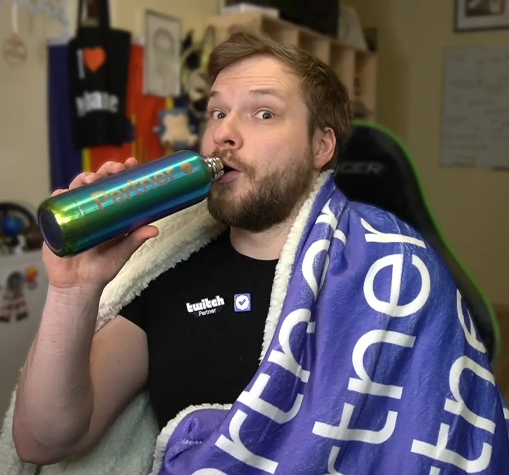 Petery celebrating Twitch partnership with a Twitch blanket and Partner bottle